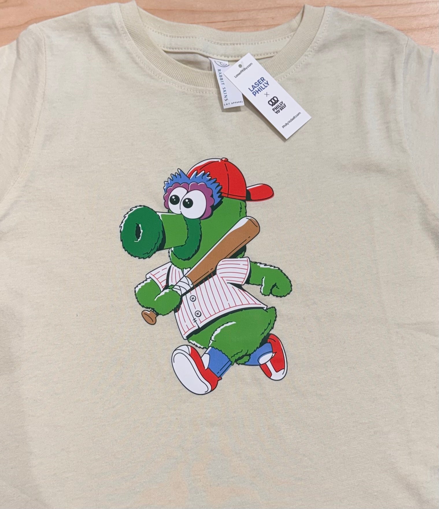 Philadelphia Phillies Phanatic Mascot as a little kid wearing a red and white striped jersey. Little Phan is front and center on this Toddler Tee that comes in sizes 2,3 and 4.